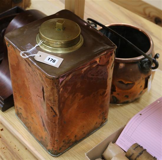 A vintage copper square canister with brass screw-on cover and a copper swing-handled cooking pot